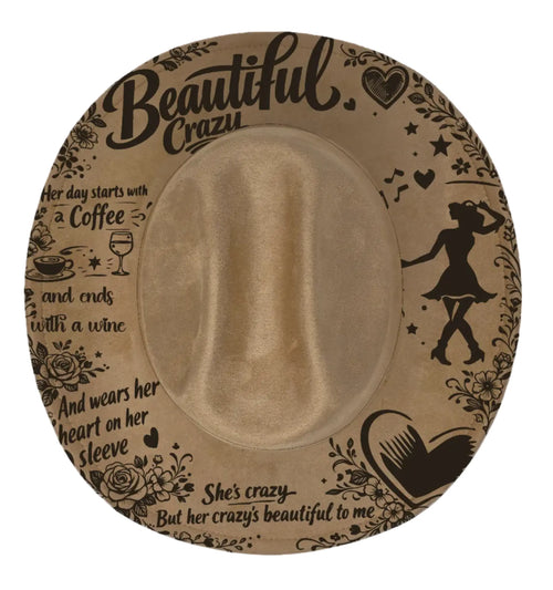 Beige cowboy hat with black text and graphics on a white background