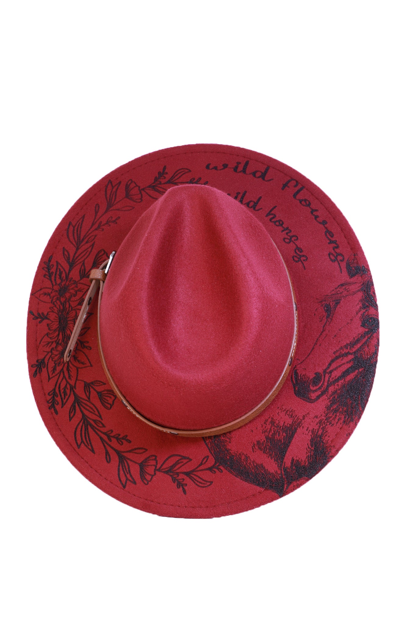 Close-up of the “wild flowers, wild horses” engraving on a burgundy wide-brim fedora