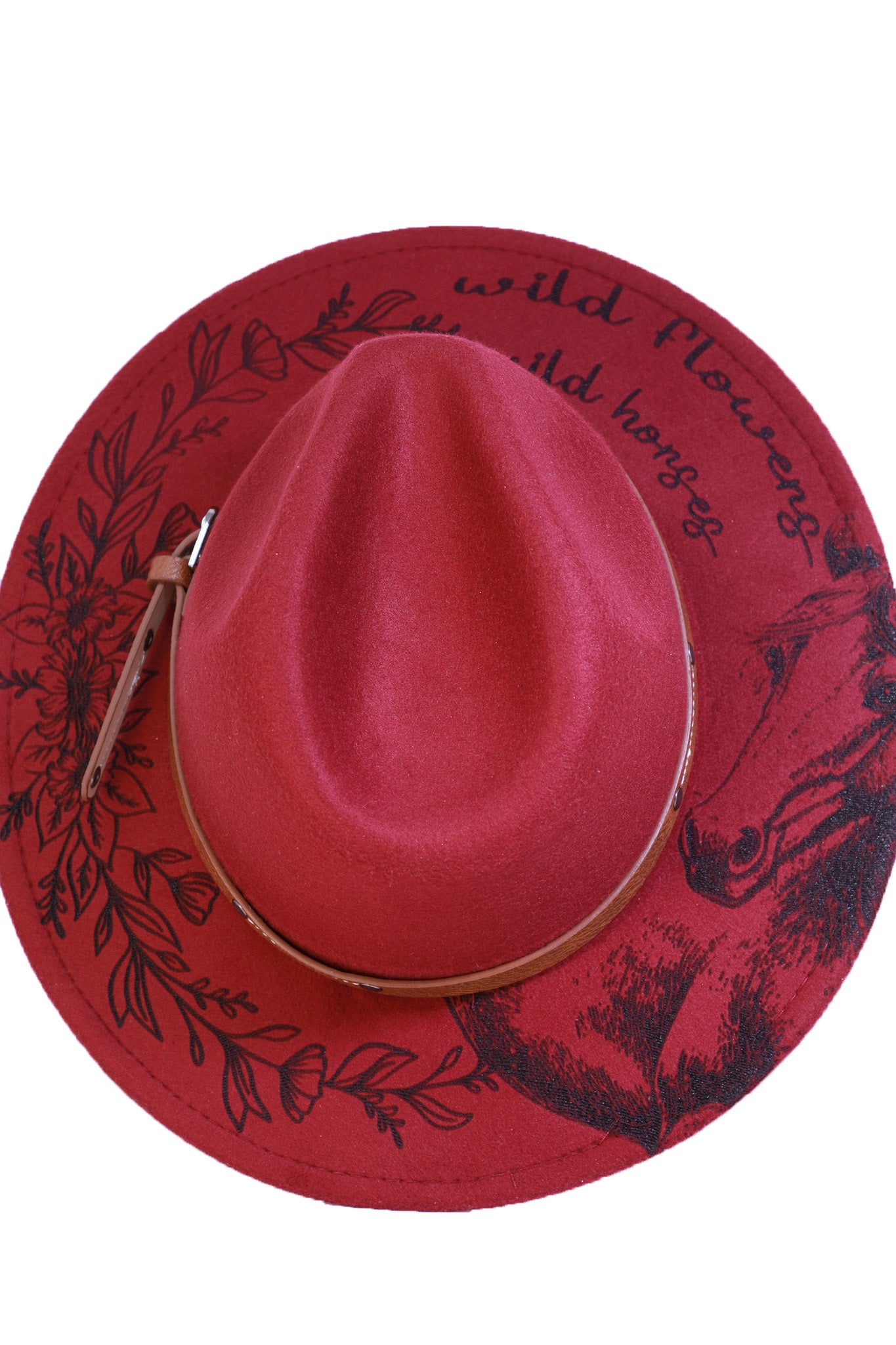 Detailed view of the engraved horse artwork on the brim of a burgundy fedora hat