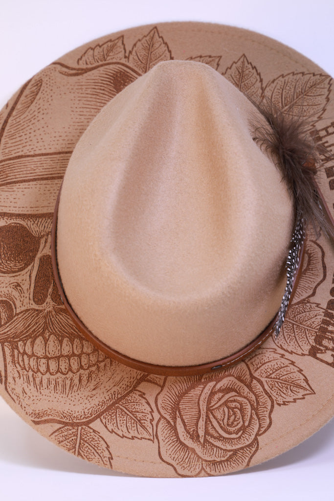 Close-up of laser-engraved “Cowboy Until Death” design