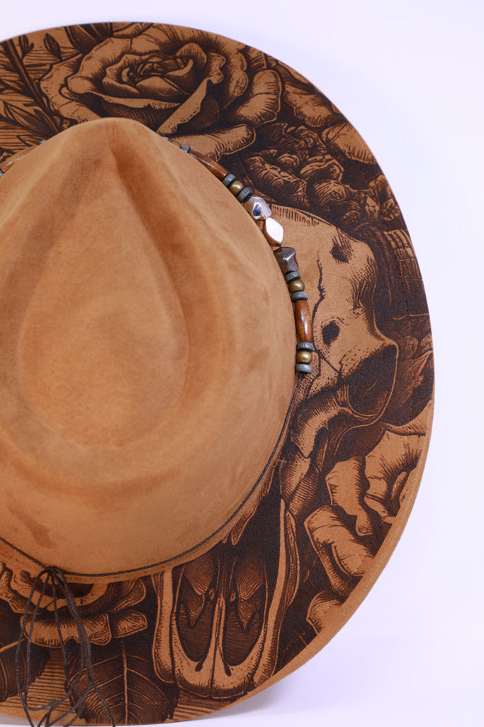 Close-up of engraved longhorn skull and floral brim detail