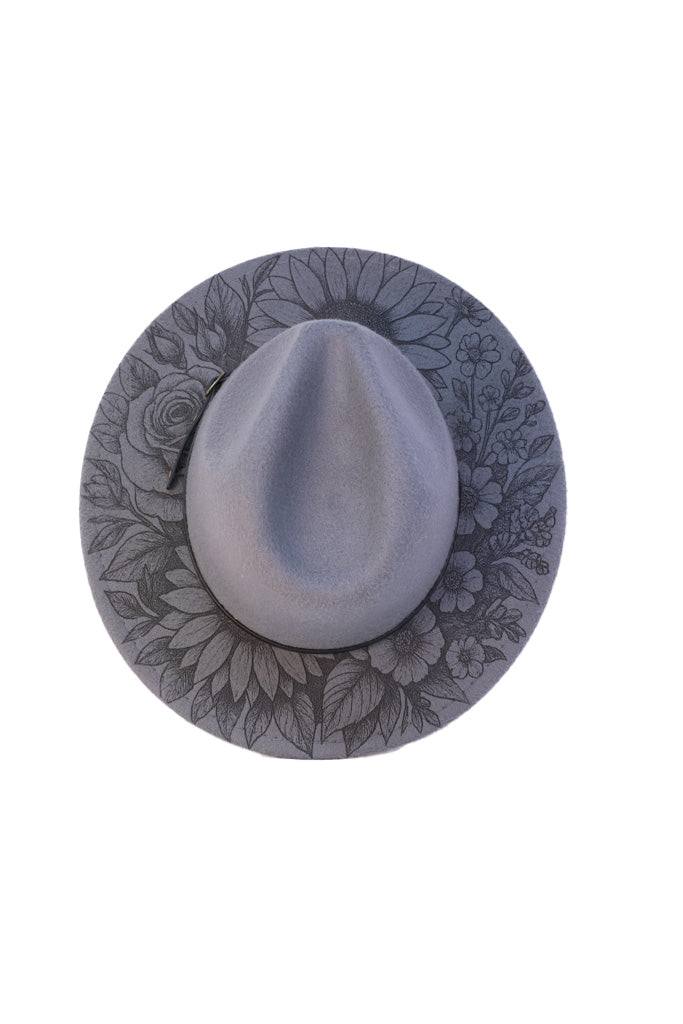 Detailed laser engraving of wildflowers on fedora brim