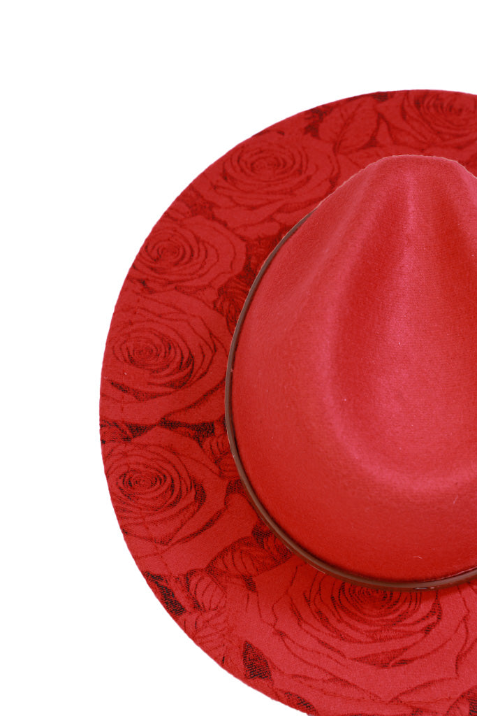 Close-up of rose engraving on red hat brim