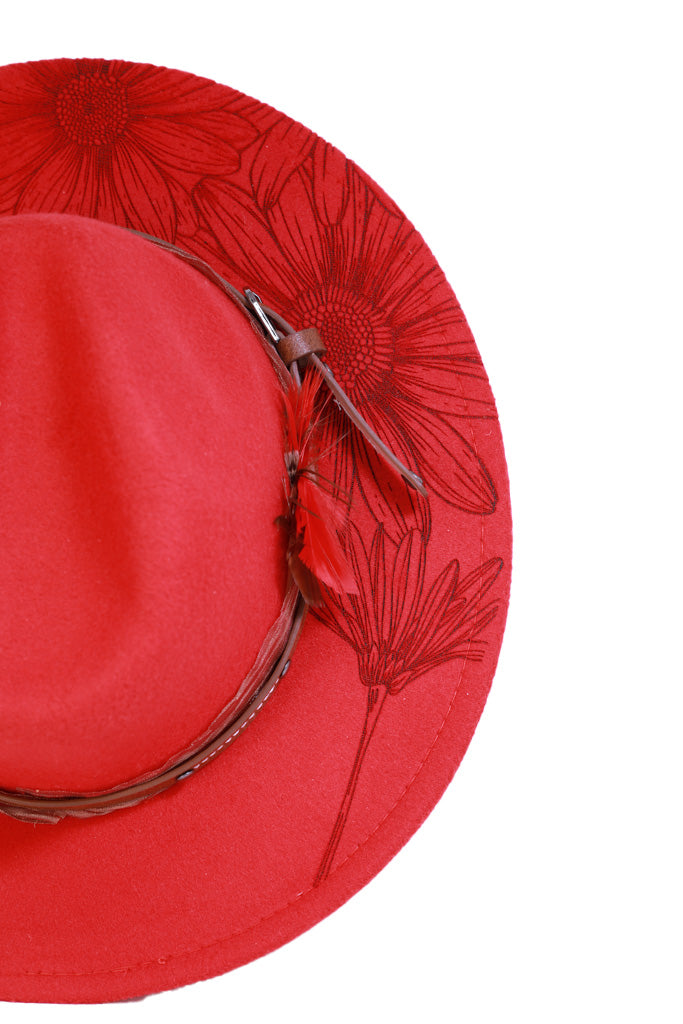 Close-up of engraved floral detail on red brim hat