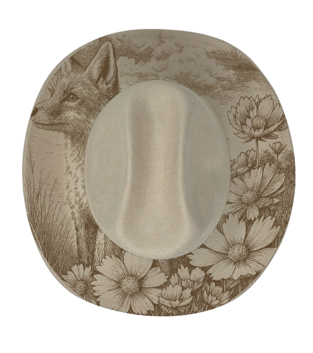 Fox in a meadow engraved onto a biege cattleman hat