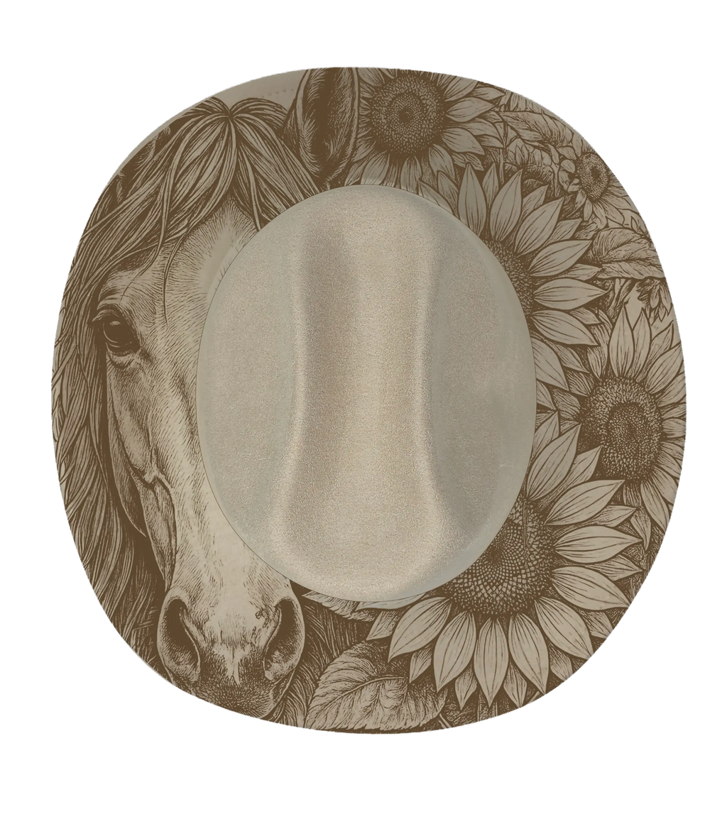 A horse face with sunflowers engraved onto a biege cattleman hat brim