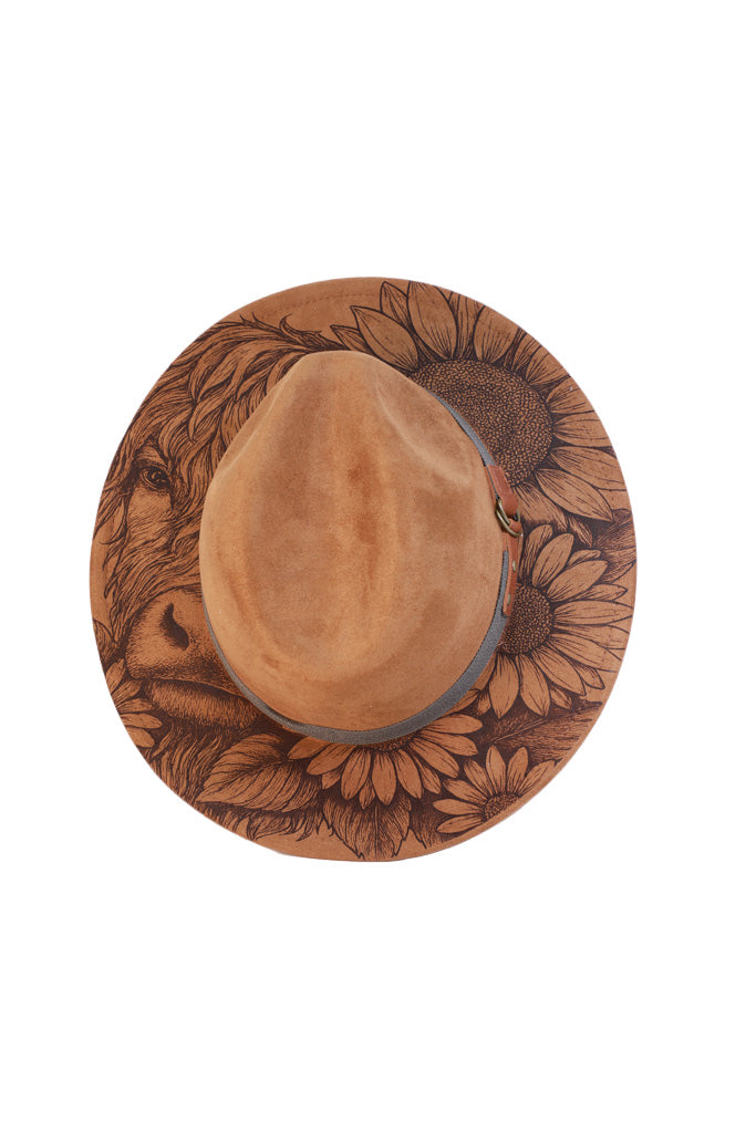 highland cow with sunflower design engraved onto a brown fedora hat