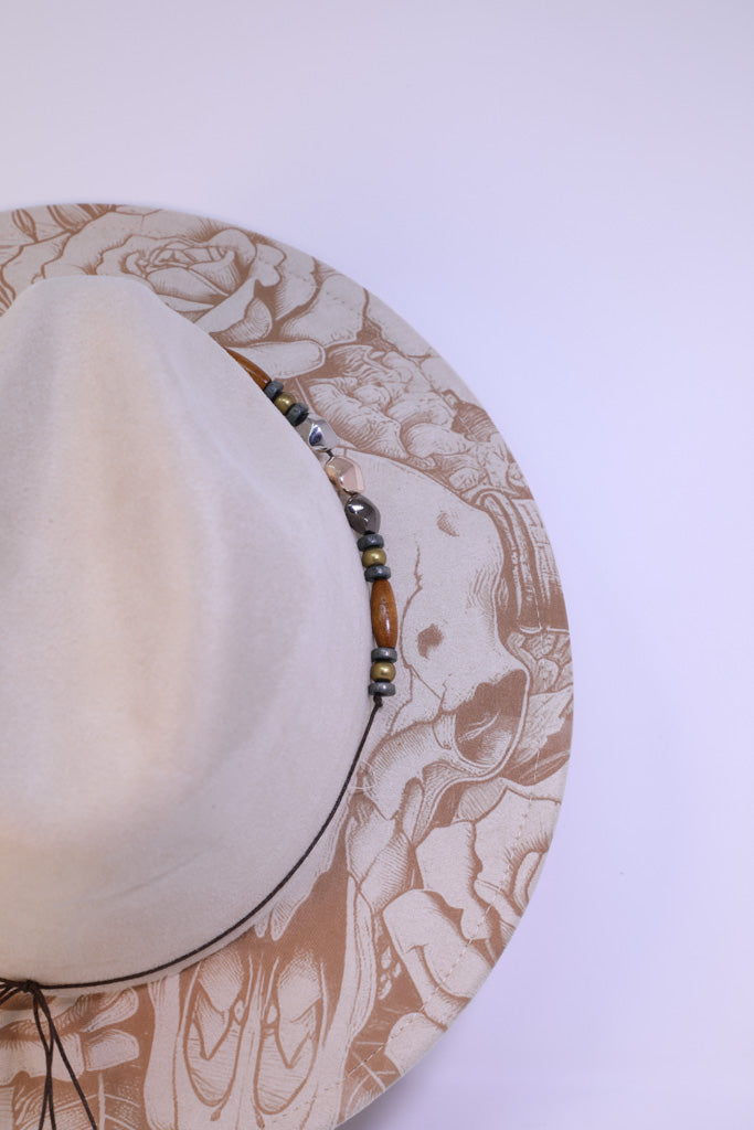 Close-up of engraved longhorn skull and roses on brim
