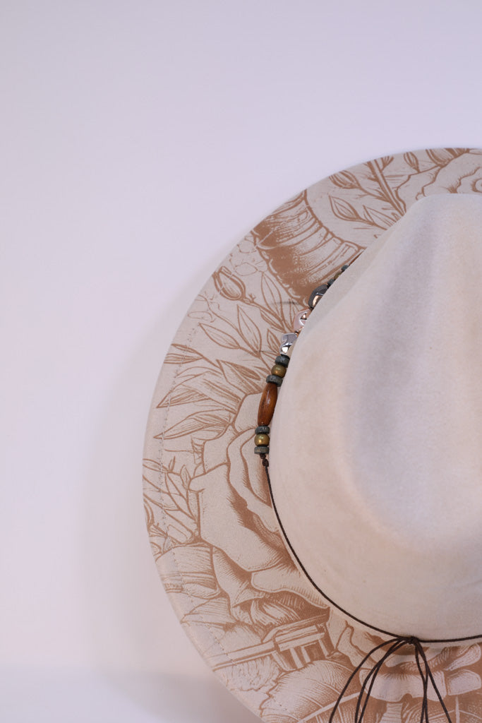 Close-up of engraved longhorn skull and roses on brim
