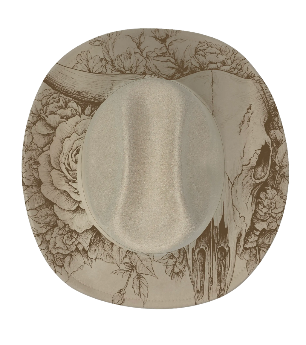 A longhorn and rose engraved onto a biege cattleman hat brim