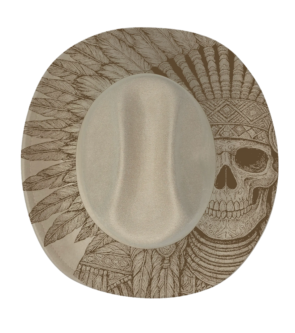 A biege cattleman hat with a native indian skull engraved onto the brim