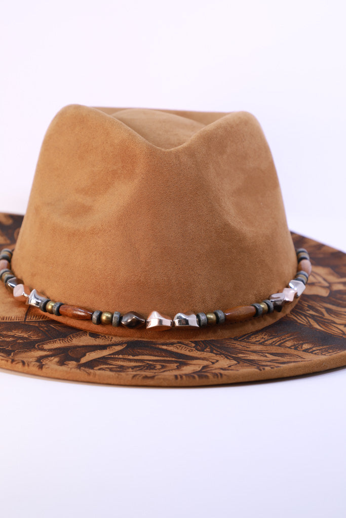 Western fedora with beaded hatband and engraved design