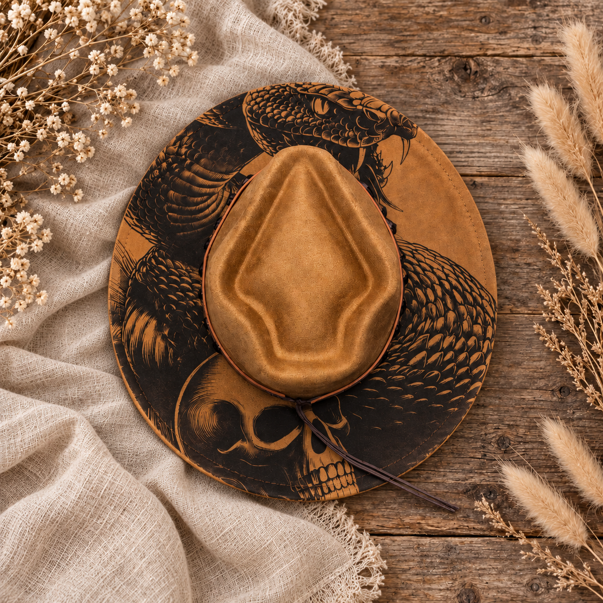 Arrowtop Snake & Skull Fedora Hat on a cream flat-lay background